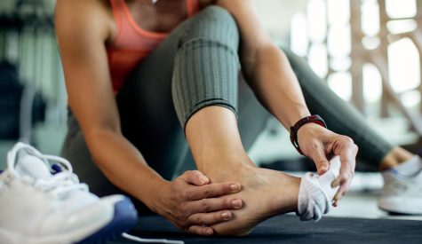 Dianella physio treating athletic woman’s injured foot after gym workout